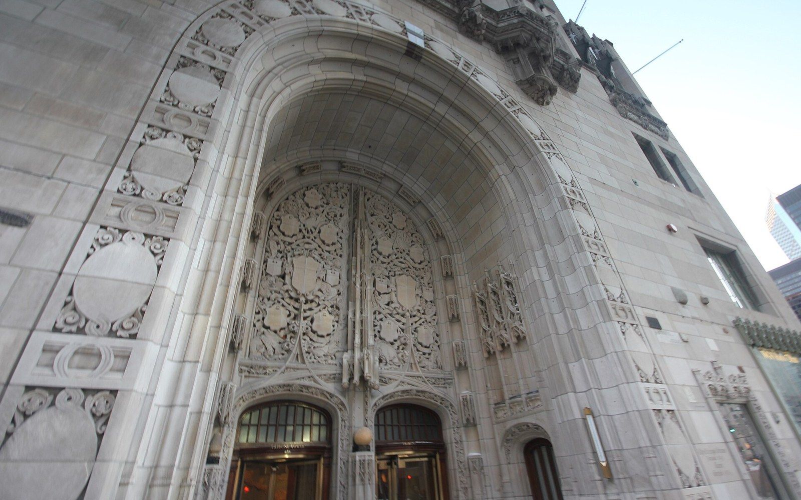 Ornate carved stone archway framing the entrance to Tribune Tower in Chicago
