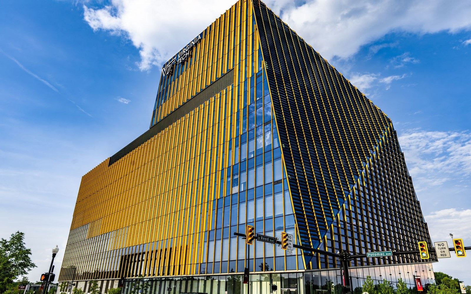 Angular Virginia Tech building with gold and black vertical fins at a street corner