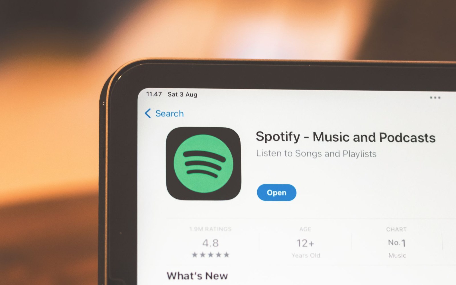 Tablet screen showing the Spotify app listing page in an app store