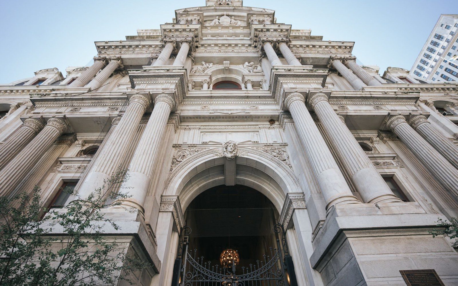 Low angle view of a courthouse facade with tall fluted columns and an arched entrance
