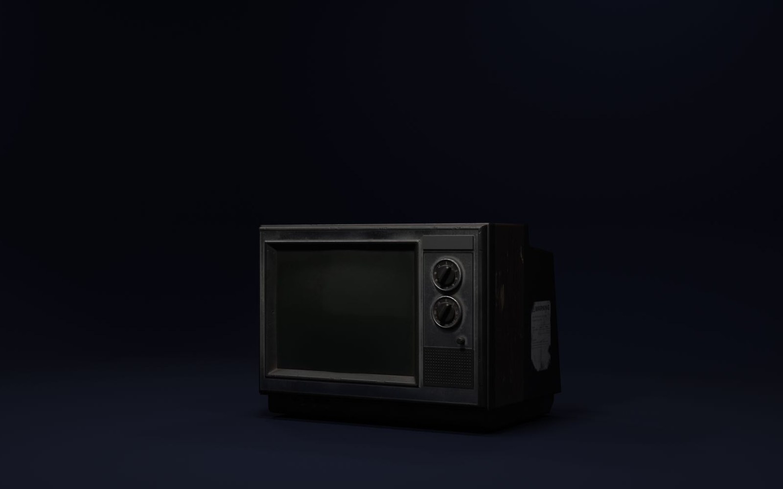 An old boxy television set with two round dial knobs, its screen dark, against a black background
